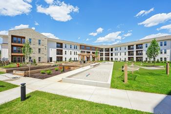 A large building with a playground in front.